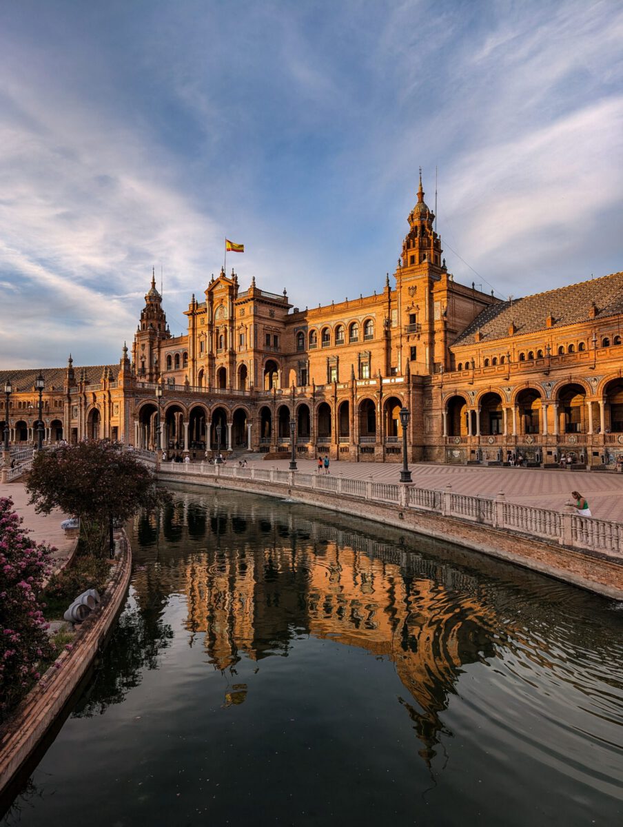Beautiful sunset at Plaza de España showcasing Spanish architecture and reflections.